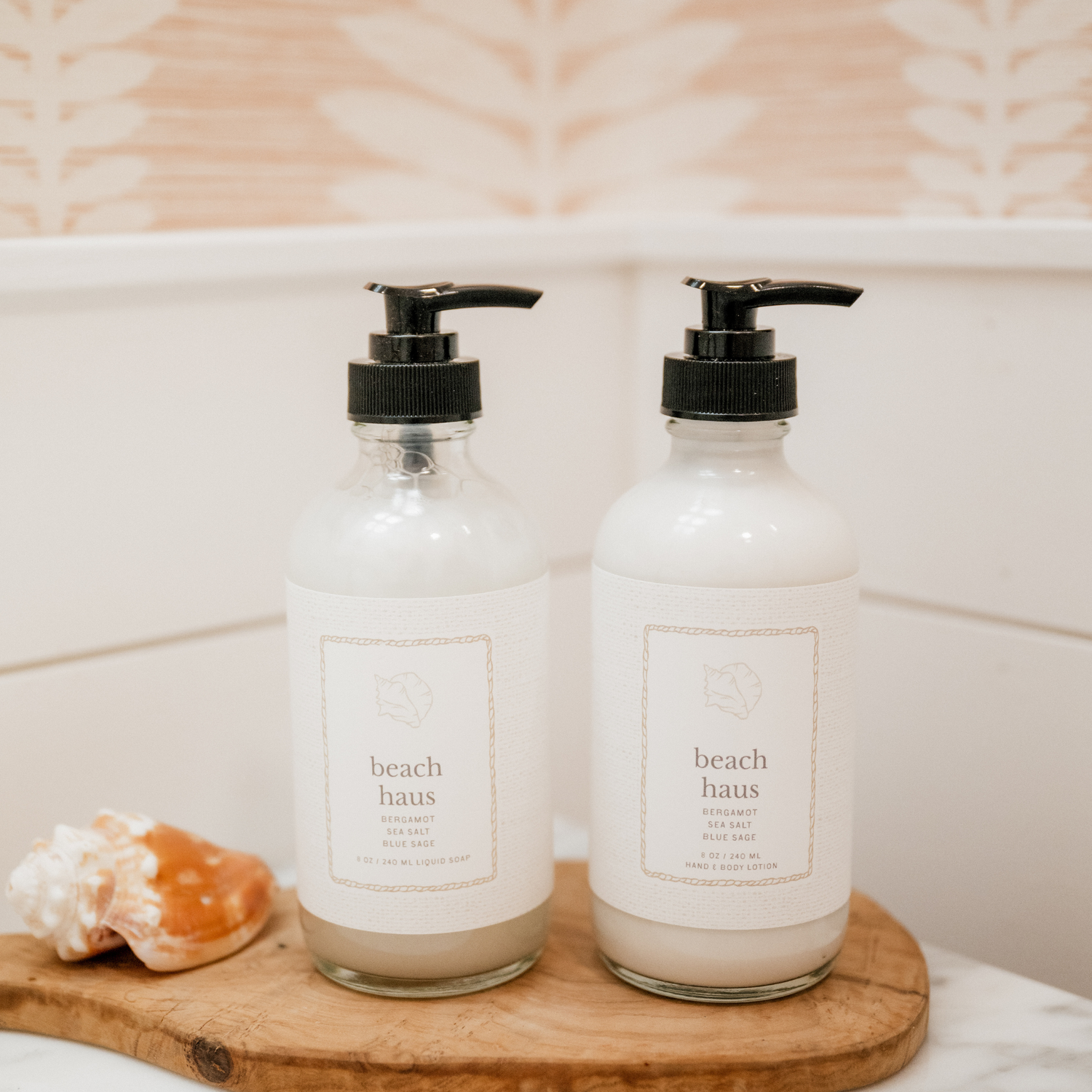 Two glass bottles with black pumps labeled &